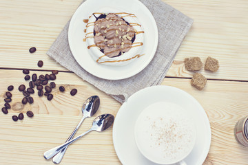 Obraz na płótnie Canvas White meringues with brown chocolate stripes. Tonnet photo.