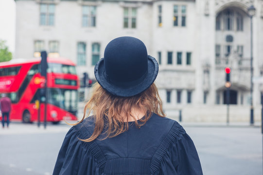 Woman in bowler hat and graduation gown