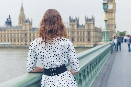 Woman on bridge at houses of parliament