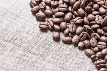 Coffee seed on linen fabric texture.
