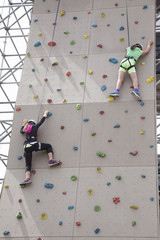 Naklejka premium women on a rock climbing wall