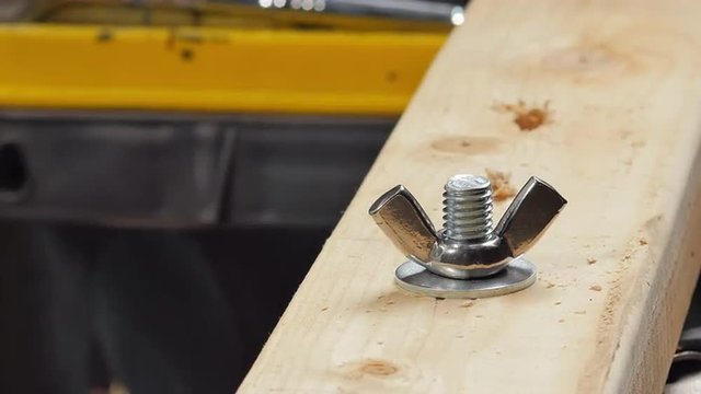 Hand Tightening a Wing Nut
