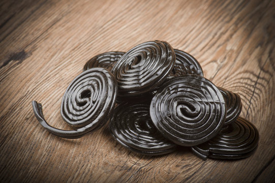 Licorice wheels candies close up on the wood