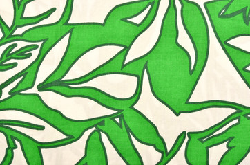 Pattern with leaves on white fabric. Green graphic leaves print as background.