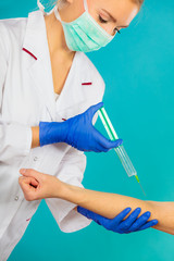 doctor with syringe giving injection to patient.