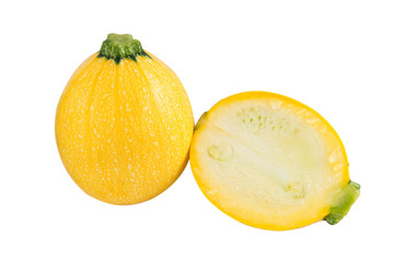 Raw round yellow zucchini and a cut one on a white background. Isolated