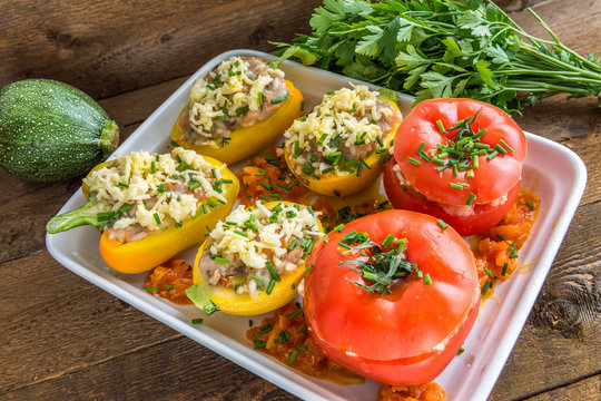 Stuffed vegetables before baking on wooden background. Above view