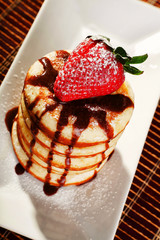 Pancakes with chocolate and strawberries
