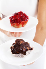 Young woman with two cakes