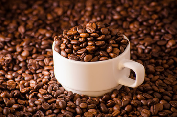 Coffee cup and coffee beans around