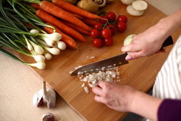 Cook's hands preparing vegetable salad - closeup shot