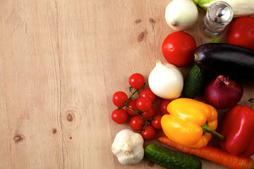 Composition with assorted raw organic vegetables wooden table