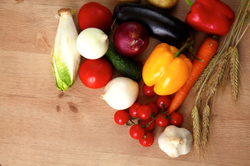Composition with assorted raw organic vegetables wooden table