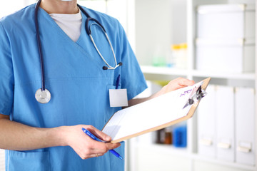 Closeup portrait of a  doctor with stethoscope holding folder