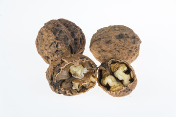 Walnut and a cracked walnut on the white background
