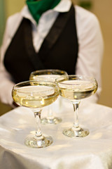 Three glasses of Champagne and a waiter