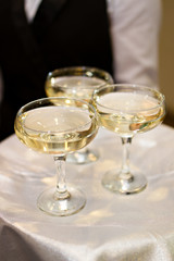 Three glasses of Champagne and a waiter