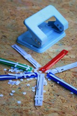 paper puncher and plastic tongue to the file