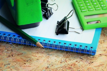 Mix book and calculator, stapler, tape, paper punch, pencil