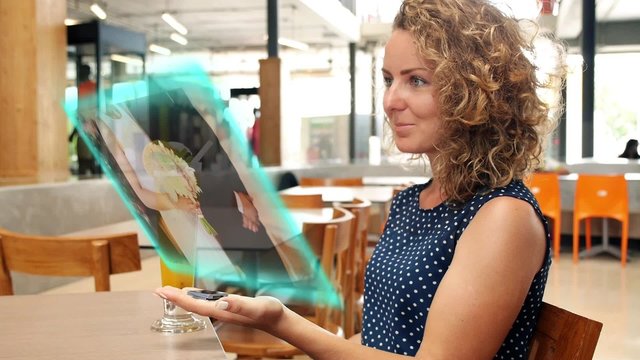 Girl Use Futuristic Hologram Interface in Public Place. Watching