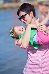 Fototapeta premium mom and baby on beach have fun