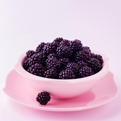 BlackBerry is on the pink plate. Isolated background.