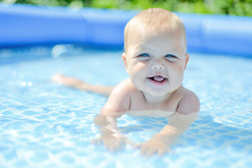 Fototapeta na wymiar little baby in the water pool