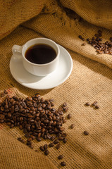 Coffee cup and coffee beans around