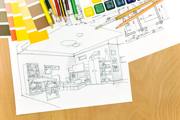 architectural plans of room interior on a desk with painting tools