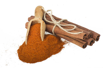 cinnamon sticks with powder on the white background