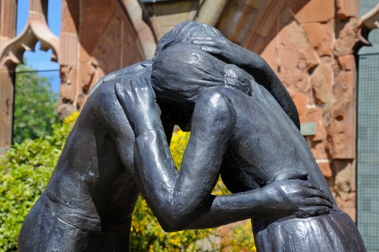 Reconciliation statue in Coventry Cathedral ruin.