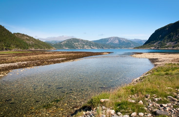 Obraz premium River estuary in Tosen fjord. Scenic landscape in Bindal in Nordland, Norway on a sunny summer day.