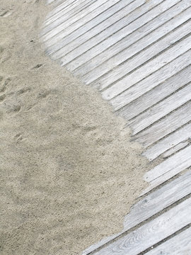 Rustic Yin Yang shape on sandy boardwalk vertical image.