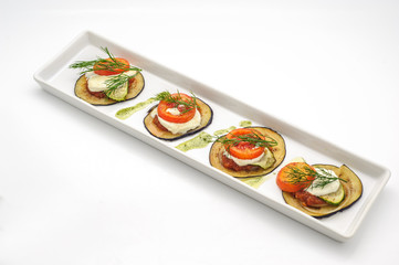 Hot appetizer with fried eggplant isolated on white