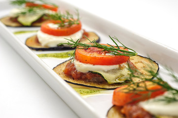 Hot appetizer with fried eggplant isolated on white