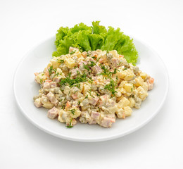 Olivie salad with mayonaisse isolated on white