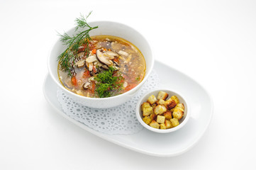 Chicken soup with pile of rusks isolated on white