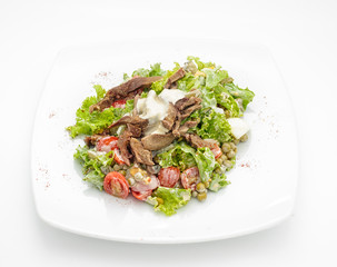 Salad with meat and cherry tomatoes isolated on white