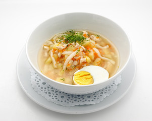 Noodles soup with egg isolated on white