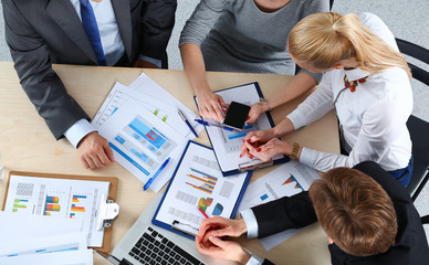 Business people sitting and discussing at business meeting, in