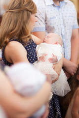 Girl on mother hands, baptism