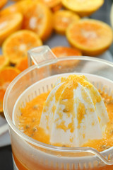 juicer machine with hand, fresh orange juice