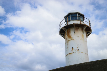 Lighthouse on a sunny day with blue sky.