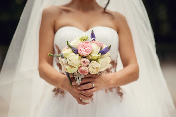Bride hands with wedding bouquet