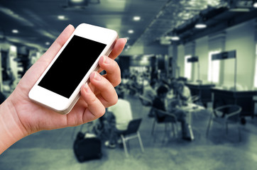 woman hand holding the phone tablet on blur market background