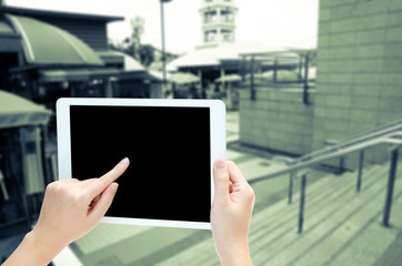 woman hand holding the phone tablet on blur market background