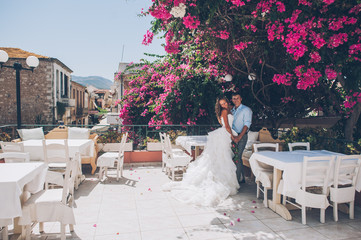 wedding couple in a cafe on summer terrace, Greece