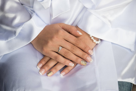 Bridal hands with engagement ring