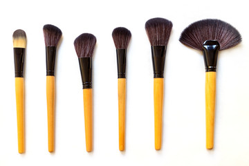 Set of makeup brushes isolated on white background.