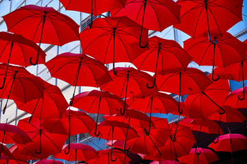 Fototapeta na wymiar Red Umbrellas In the Air